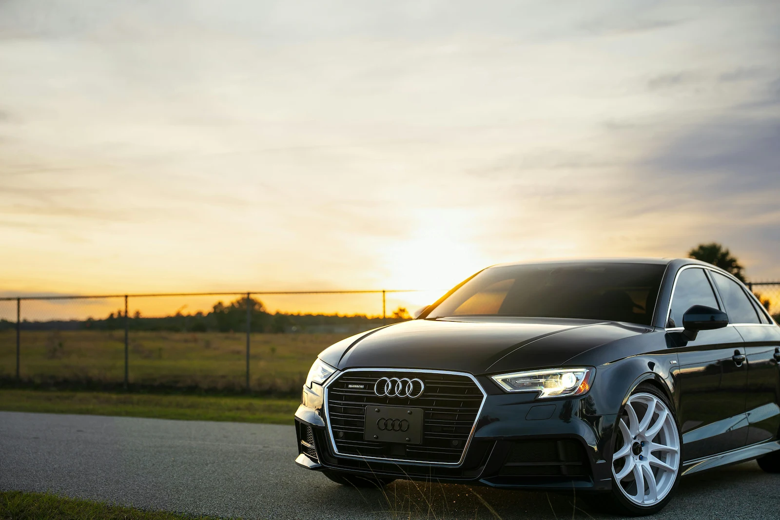 Black Audi keyless car parked at sunset